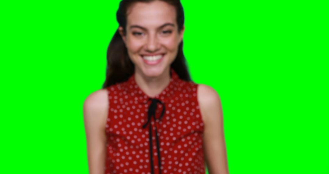 Smiling Woman in Red Polka Dot Blouse with Green Screen - Free Images, Stock Photos and Pictures on Pikwizard.com