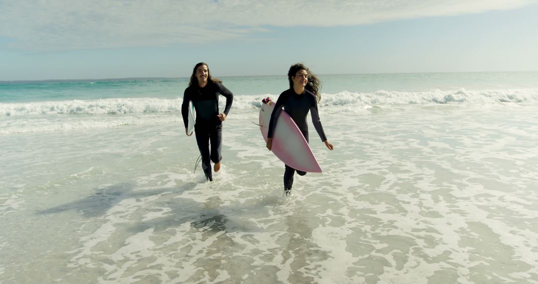 Two Surfers Running with Surfboards on Beach - Free Images, Stock Photos and Pictures on Pikwizard.com