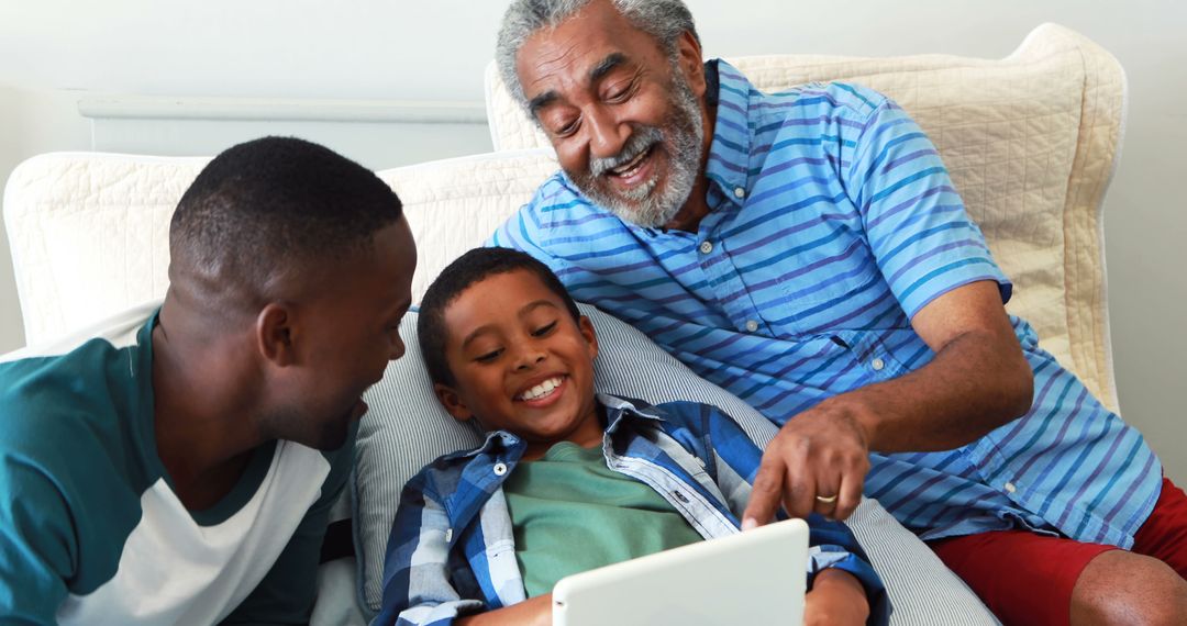 Grandfather and Grandchildren Enjoying Tablet Together on Couch - Free Images, Stock Photos and Pictures on Pikwizard.com