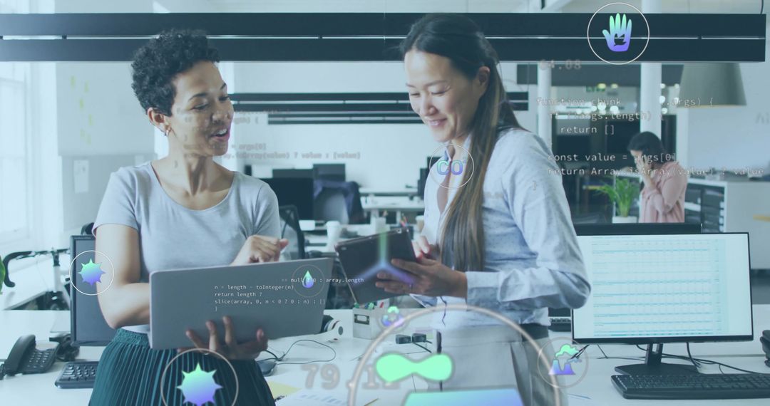 Women Collaborating on Code in Modern Tech Office