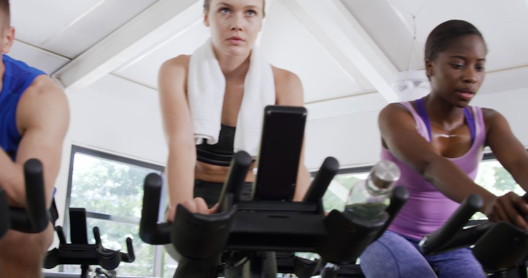 Determined Cyclists in Indoor Spin Class - Free Images, Stock Photos and Pictures on Pikwizard.com