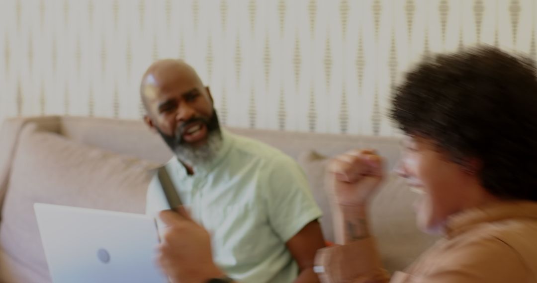 Smiling Friends Chatting with Smartphone and Laptop on Couch