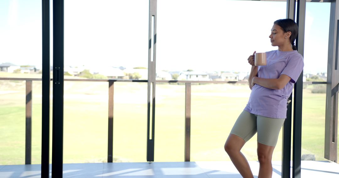 Woman Relaxing with Coffee Looking at Scenic View Through Window