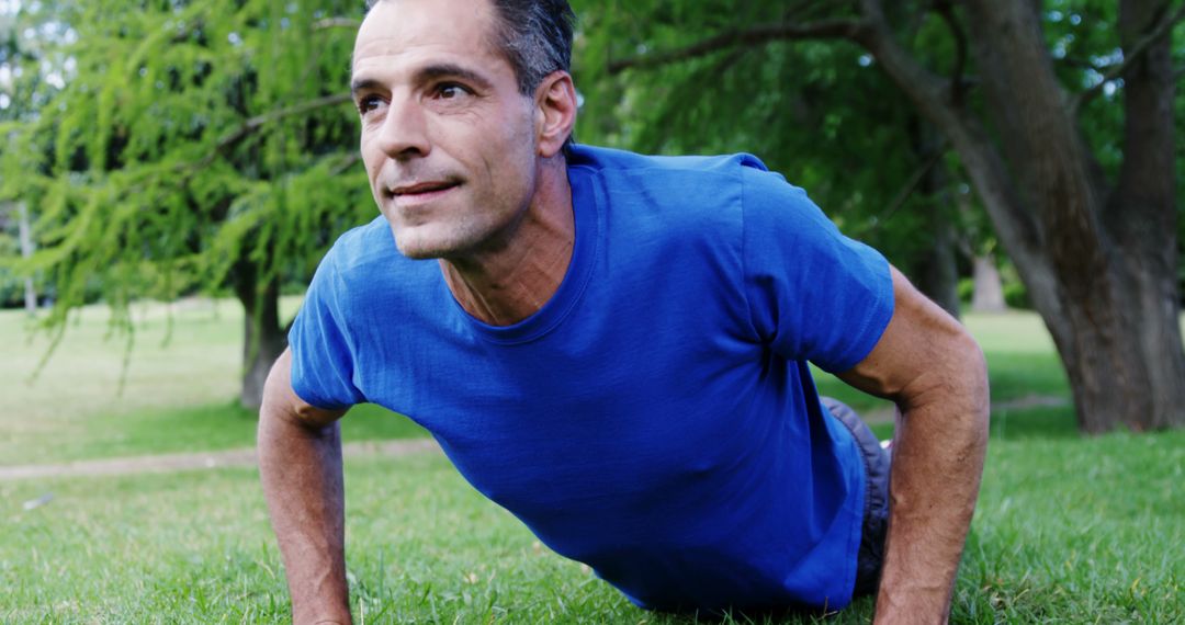 Middle-aged Man Exercising Outdoors Doing Push-ups - Free Images, Stock Photos and Pictures on Pikwizard.com