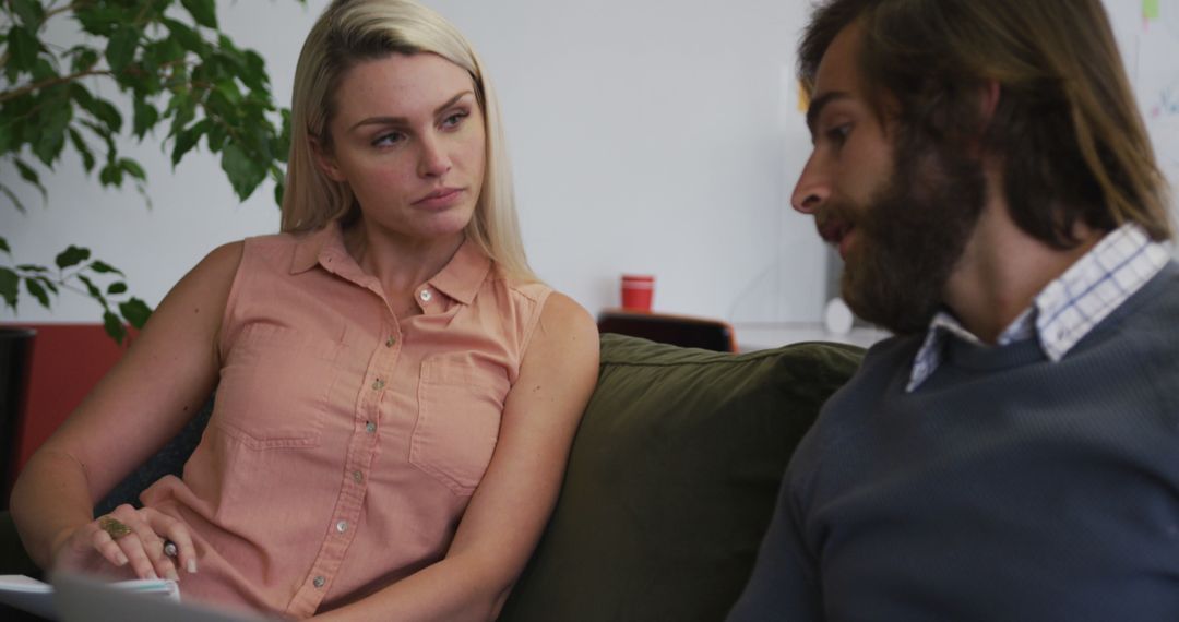 Colleagues Discussing Work Documents in Modern Office Space