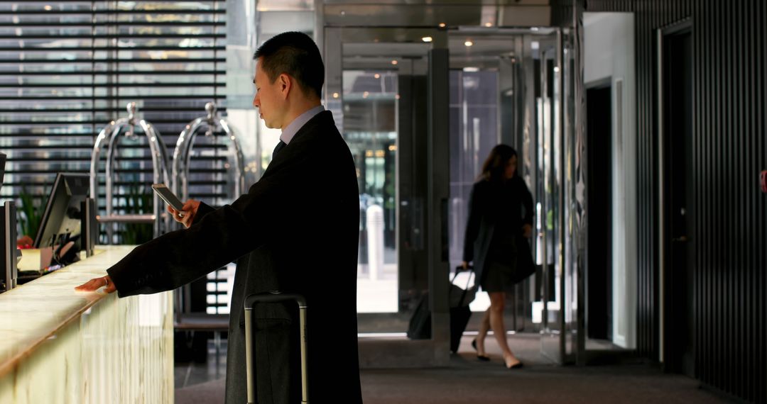 Businessman Checking Into Hotel while Woman Exits - Free Images, Stock Photos and Pictures on Pikwizard.com