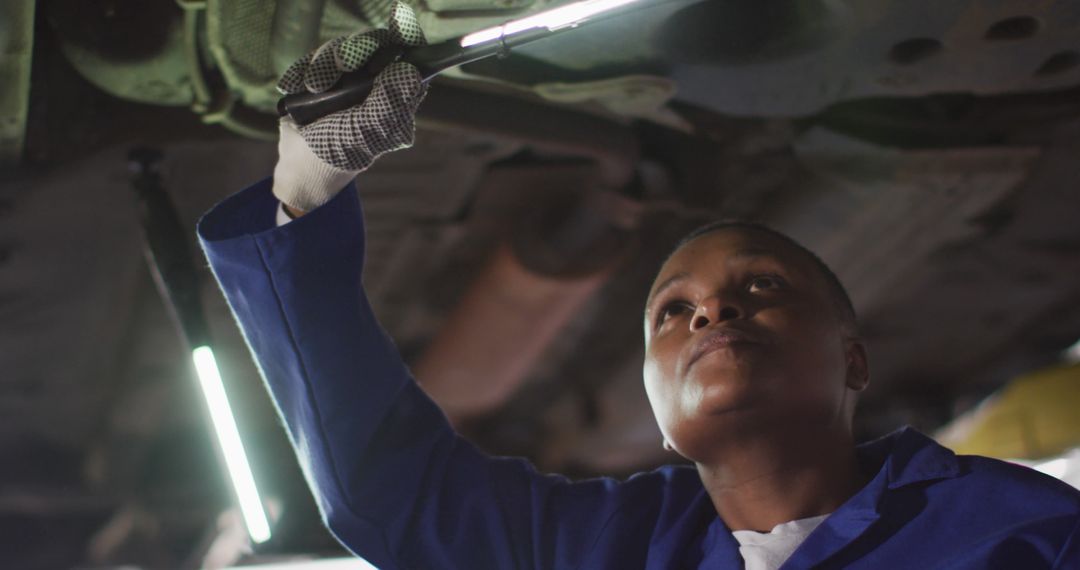 Female Mechanic Inspecting Underside of Vehicle in Auto Repair Shop - Free Images, Stock Photos and Pictures on Pikwizard.com