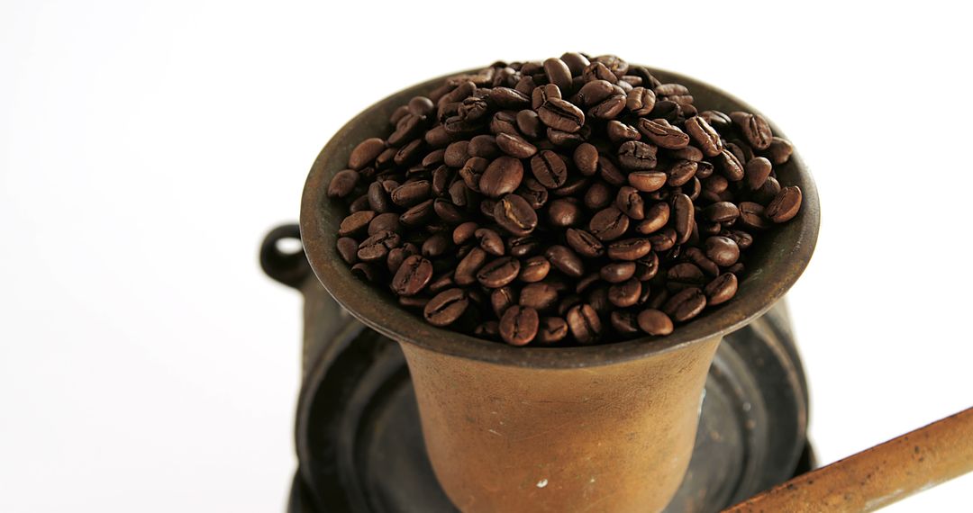 Close-Up of Coffee Beans in Old Coffee Grinder on White Background - Free Images, Stock Photos and Pictures on Pikwizard.com