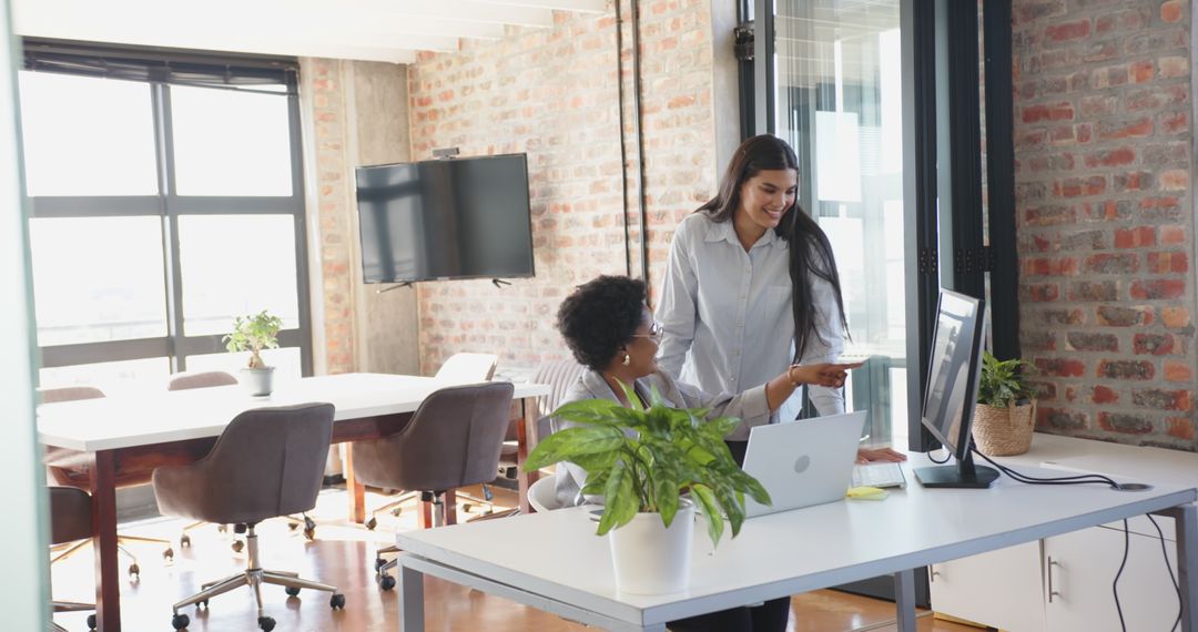 Diverse Female Coworkers Collaborating in Open-Plan Office Modern Workspace