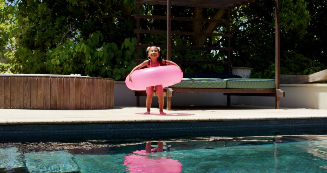 Joyful Child Playing with Pink Float by Poolside - Free Images, Stock Photos and Pictures on Pikwizard.com