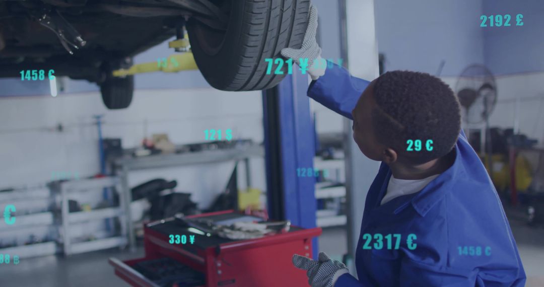 Mechanic Assessing Car Tire with Digital Interface Overlay