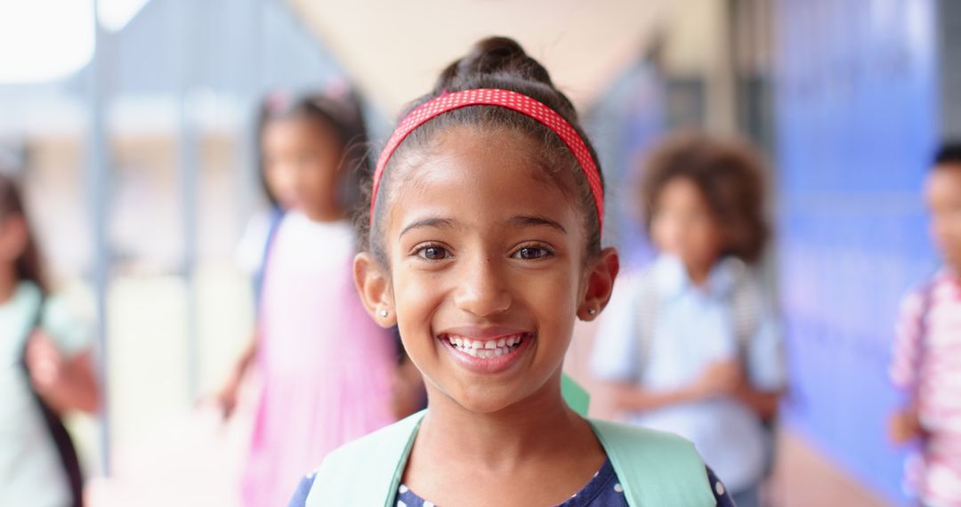 Smiling Girl in School Hallway with Backpack Ready for Learning