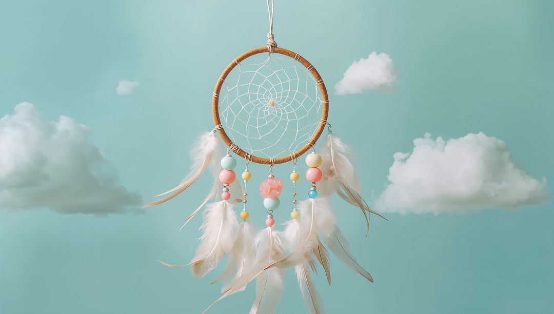 Dreamcatcher with Pastel Beads and Feathers Against Cloudy Sky