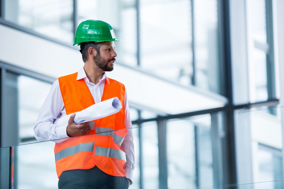 Construction Engineer Reviewing Building Plans on Site