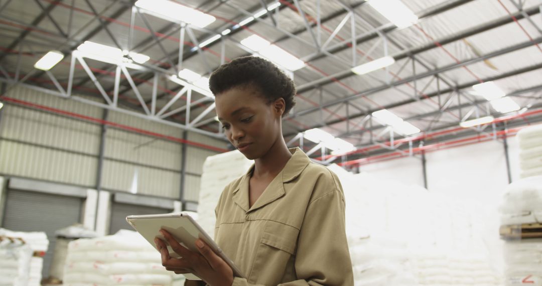 Industrial Worker Inspects Logistics Data on Tablet in Warehouse Setting - Free Images, Stock Photos and Pictures on Pikwizard.com