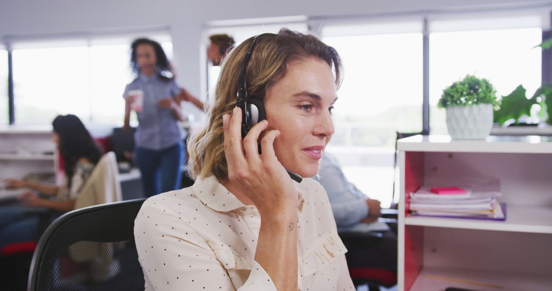 Smiling Female Call Center Agent Using Headset in Modern Office - Free Images, Stock Photos and Pictures on Pikwizard.com