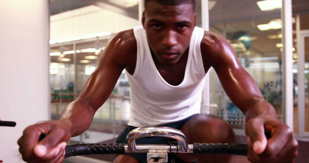 Focused Athlete Cycling in Gym, Sweating and Working Out - Free Images, Stock Photos and Pictures on Pikwizard.com