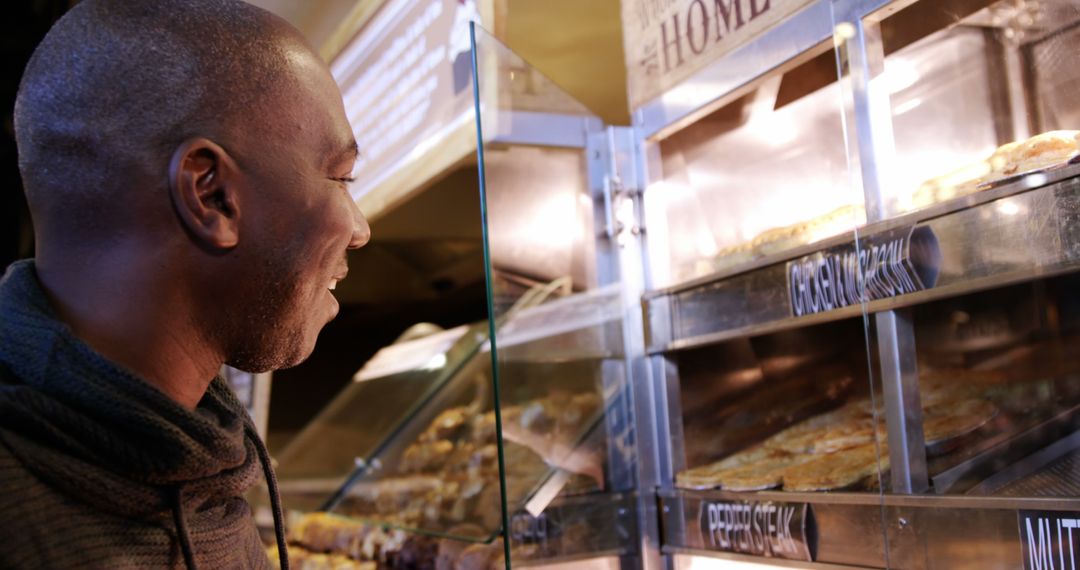 Man Choosing Pastry at Bakery Display Counter - Free Images, Stock Photos and Pictures on Pikwizard.com