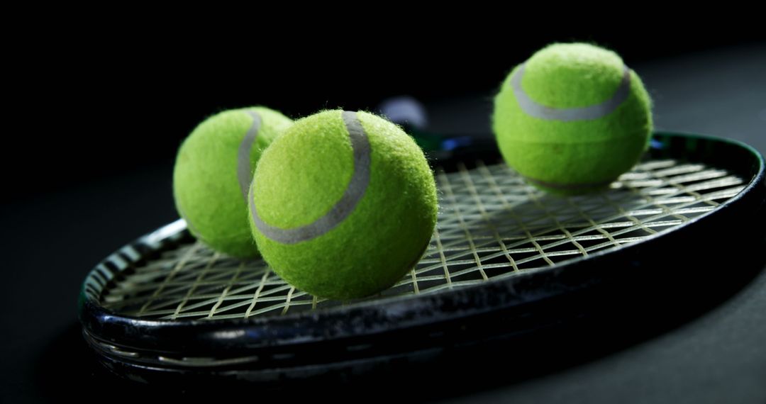 Close-up of Tennis Balls on Racket Strings in Low Light - Free Images, Stock Photos and Pictures on Pikwizard.com