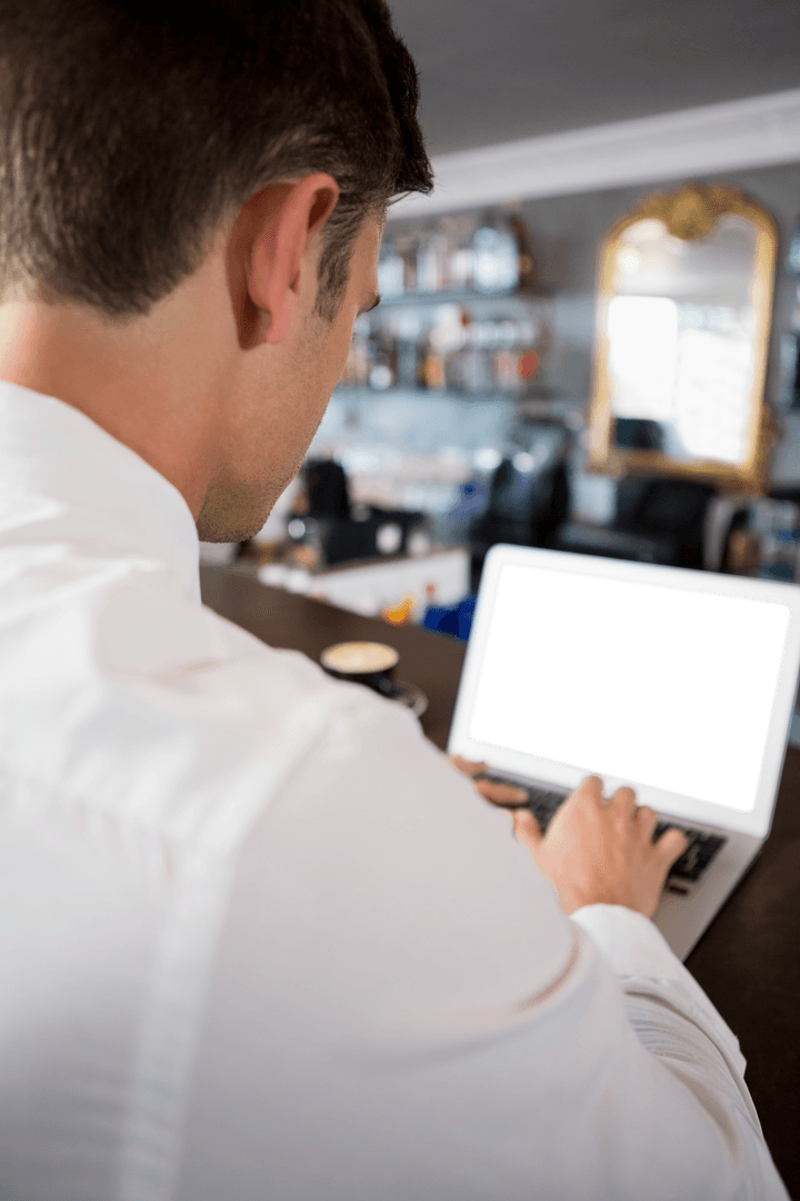 Business Professional Using Transparent Laptop in Cafe Lounge
