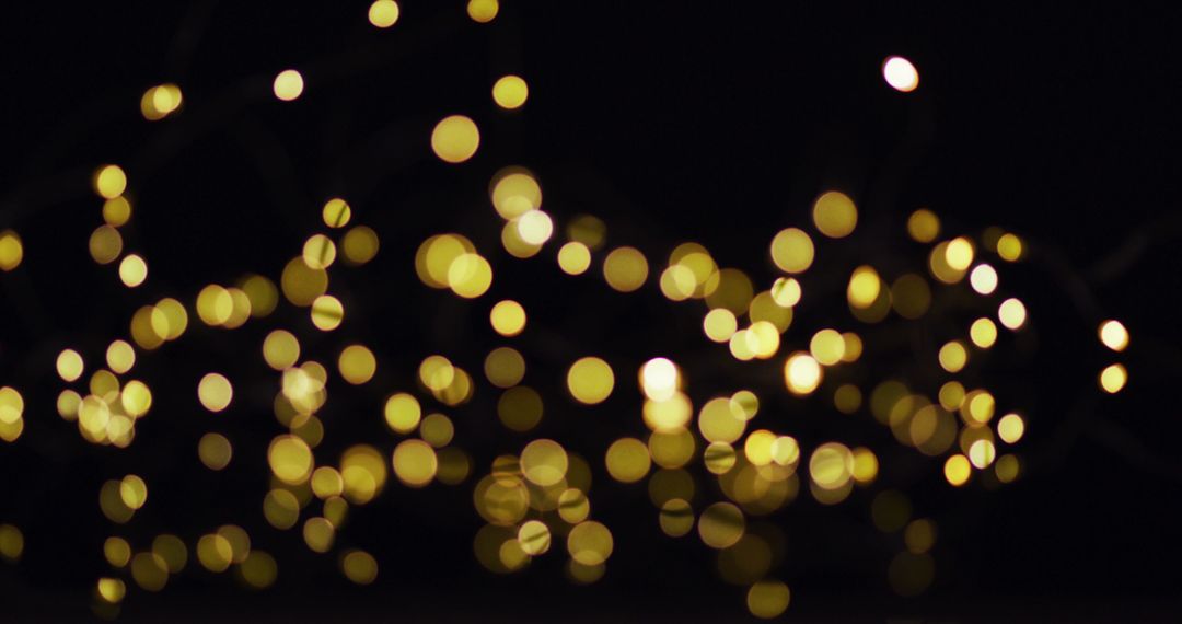 Golden Fairy Lights Glowing on Black Background for Festive Celebration - Free Images, Stock Photos and Pictures on Pikwizard.com