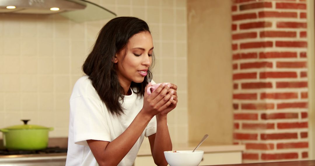 Woman Enjoying Hot Beverage in Modern Kitchen - Free Images, Stock Photos and Pictures on Pikwizard.com