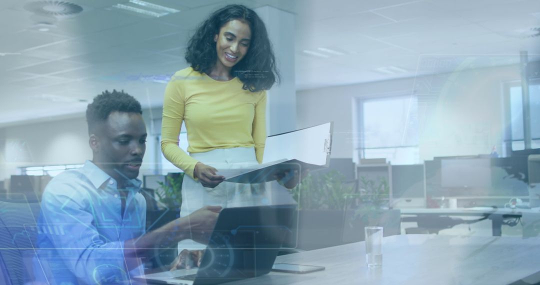 Colleagues Analyzing Data on Laptop in Modern Office