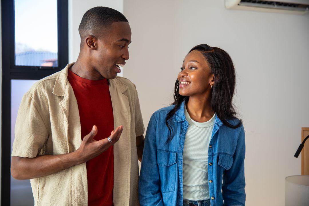 Smiling African American Couple Enjoying Conversation at Home