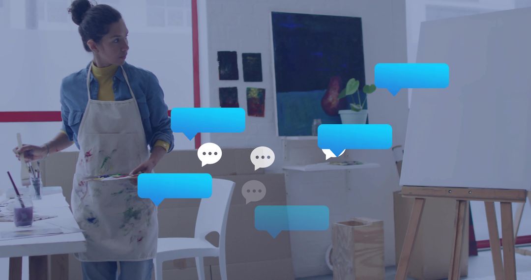 Mature Hispanic Artist in Studio Surrounded by Digital Chat Bubbles