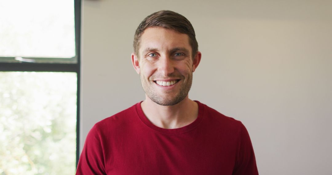 Happy Caucasian Man Relaxing at Home in Casual Red Shirt