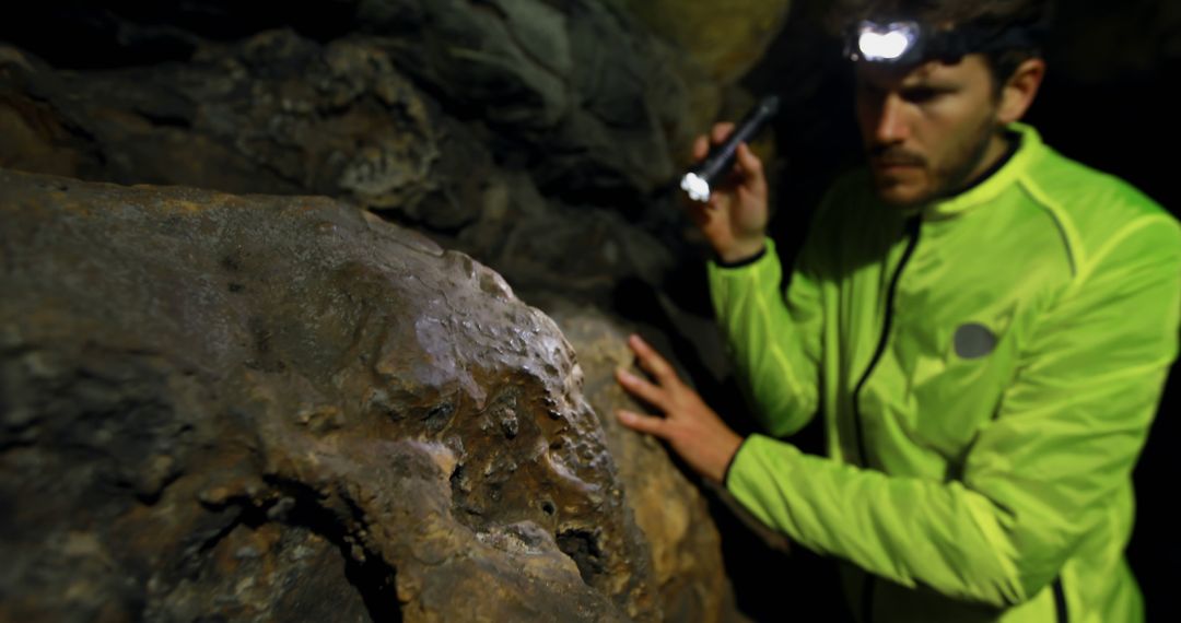 Explorer Studying Rock Formation Inside Cave with Flashlight - Free Images, Stock Photos and Pictures on Pikwizard.com