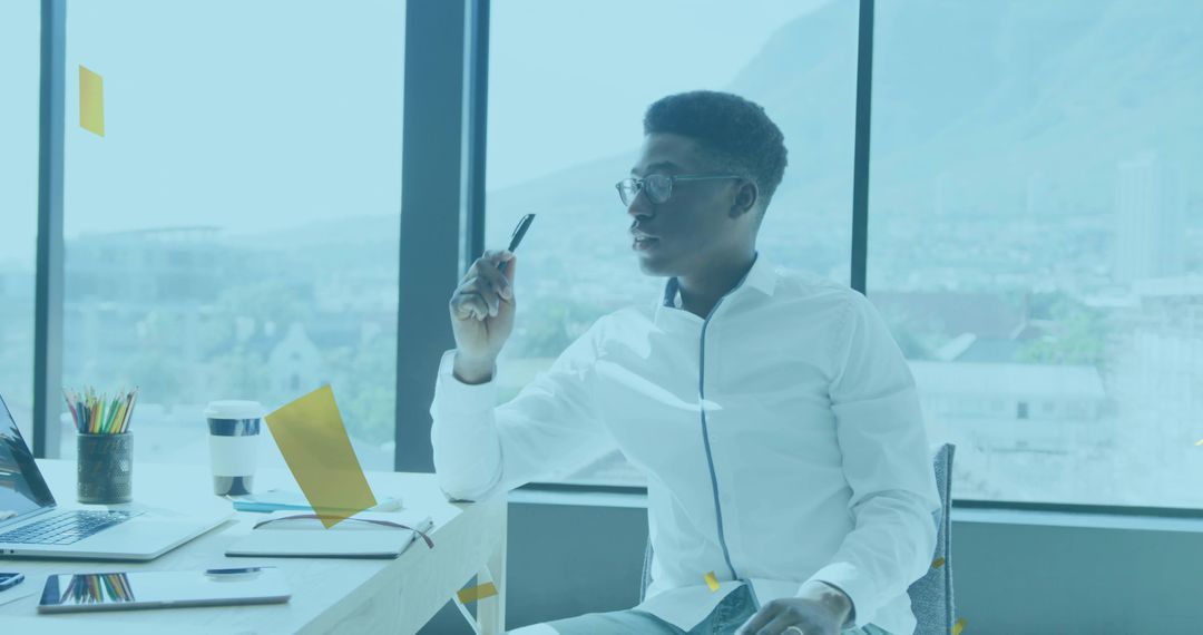 Contemplative Professional Gazing Out Window in Modern Office
