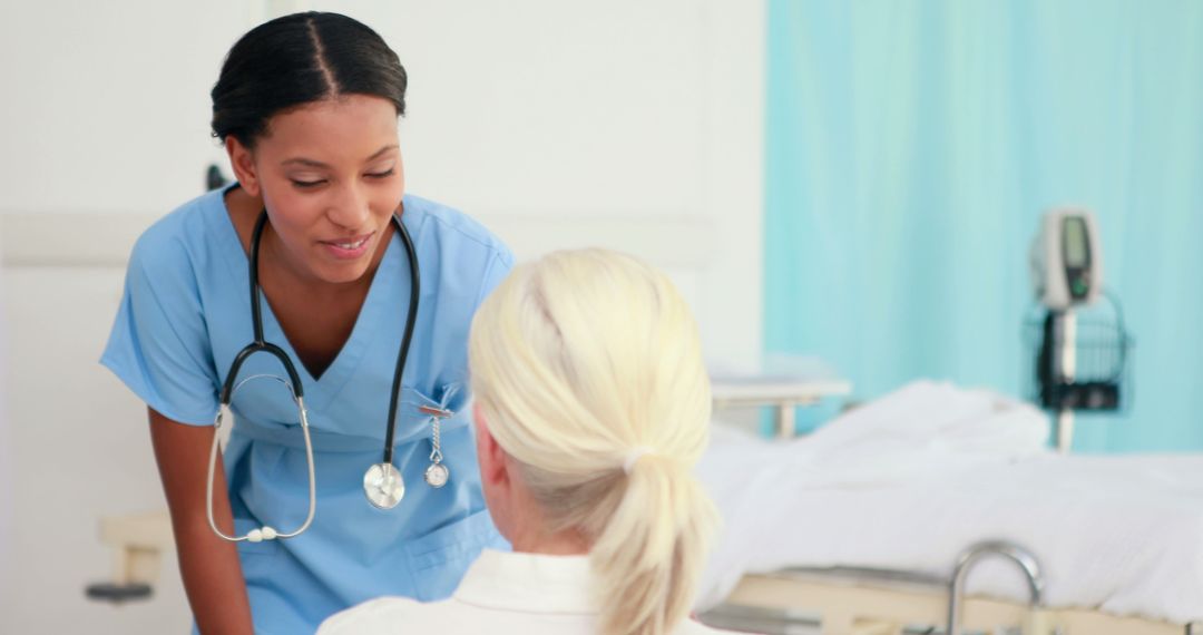 Friendly Nurse Assisting Patient in Hospital Room - Free Images, Stock Photos and Pictures on Pikwizard.com