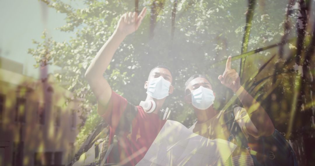 Two Friends Exploring the Outdoors with Map and Protective Masks