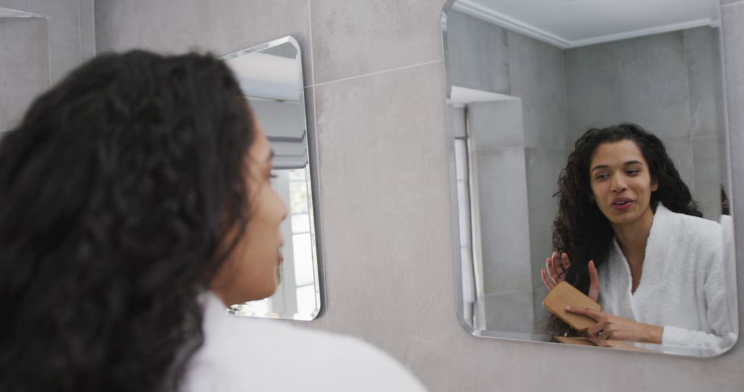 Woman with Curly Hair Preparing in Bathroom Mirror - Free Images, Stock Photos and Pictures on Pikwizard.com