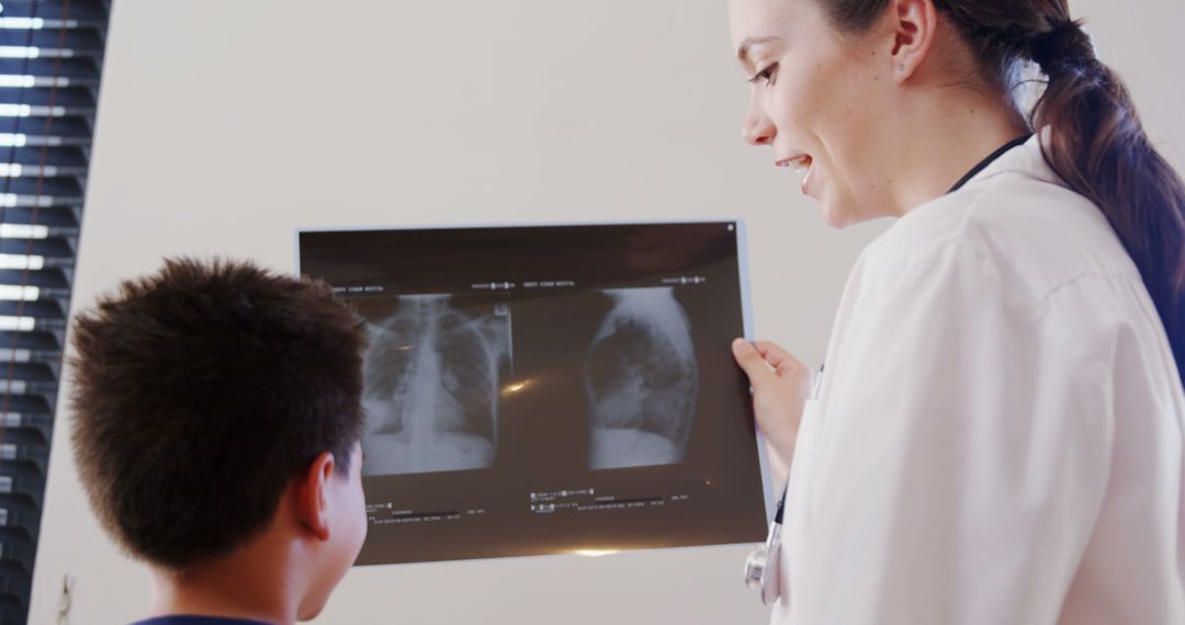 Pediatric doctor discussing chest X-ray results with young patient - Free Images, Stock Photos and Pictures on Pikwizard.com