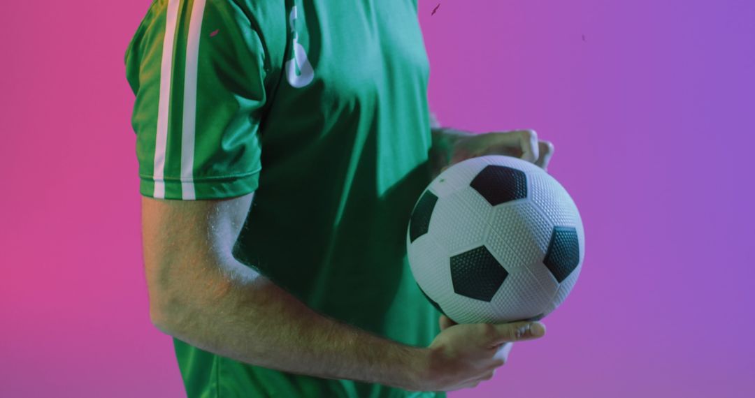 Caucasian Soccer Player Holding Ball with Vibrant Background