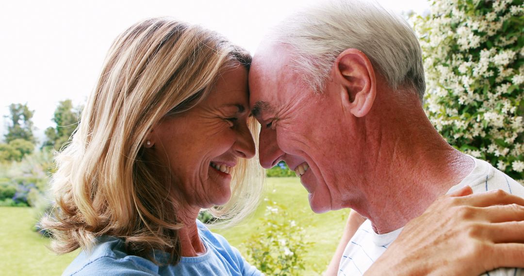 Happy Senior Couple Embracing in Garden - Free Images, Stock Photos and Pictures on Pikwizard.com