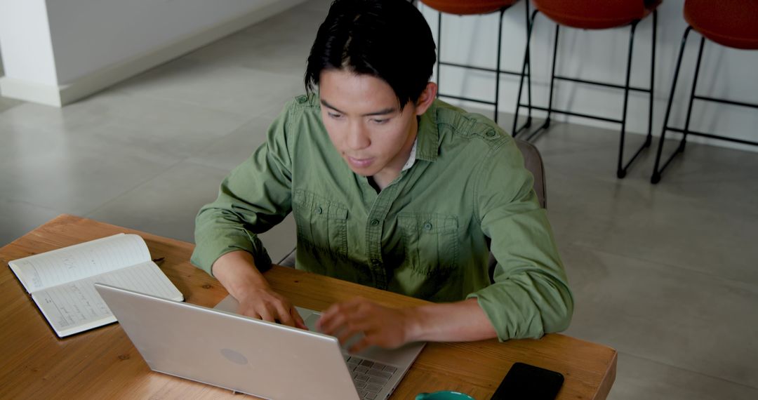 Professional in Modern Coworking Space Using Laptop