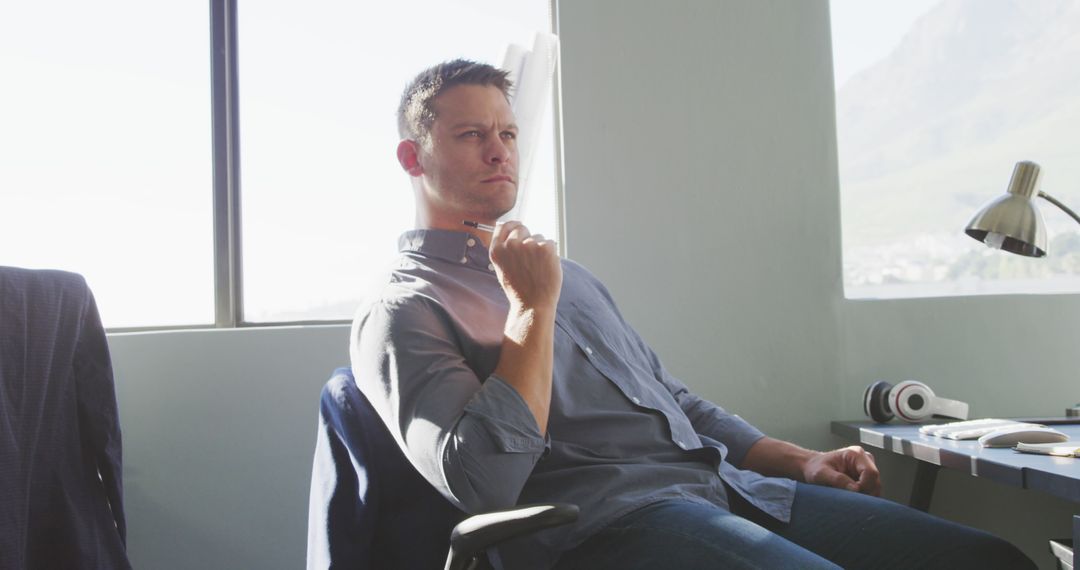 Thoughtful Man Sitting in OfficeContemplating Ideas - Free Images, Stock Photos and Pictures on Pikwizard.com