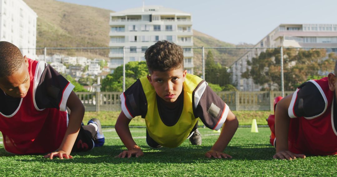 Young Football Players Training Outdoors with Push-Ups - Free Images, Stock Photos and Pictures on Pikwizard.com