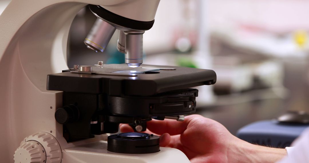 Scientist Adjusting Microscope for Laboratory Research - Free Images, Stock Photos and Pictures on Pikwizard.com