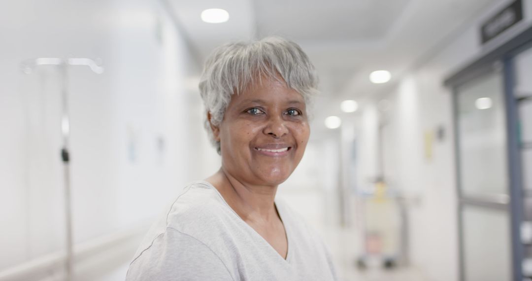 Smiling Elderly Woman in Hospital Corridor - Free Images, Stock Photos and Pictures on Pikwizard.com