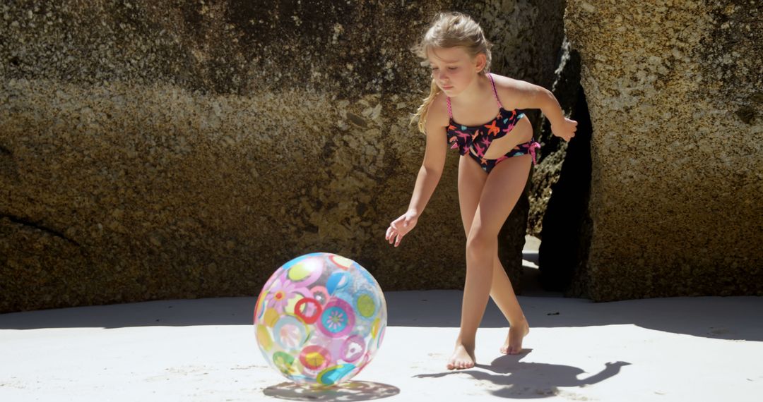 Girl Playing with Beach Ball at Sandy Beach - Free Images, Stock Photos and Pictures on Pikwizard.com