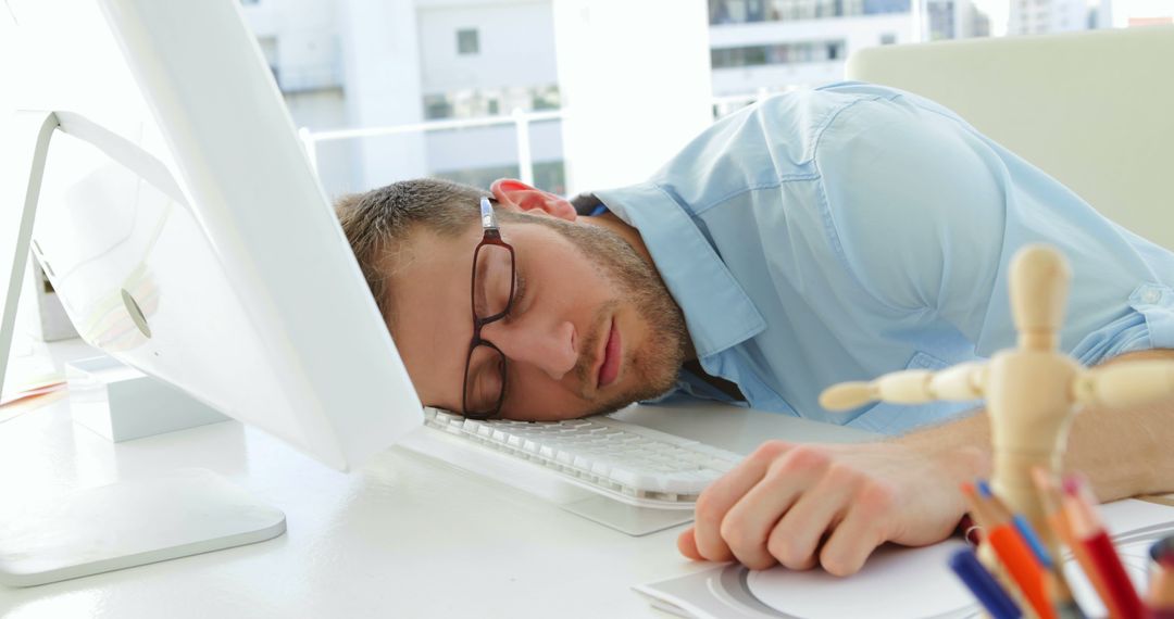 Attractive businessman sleeping in his office - Free Images, Stock Photos and Pictures on Pikwizard.com