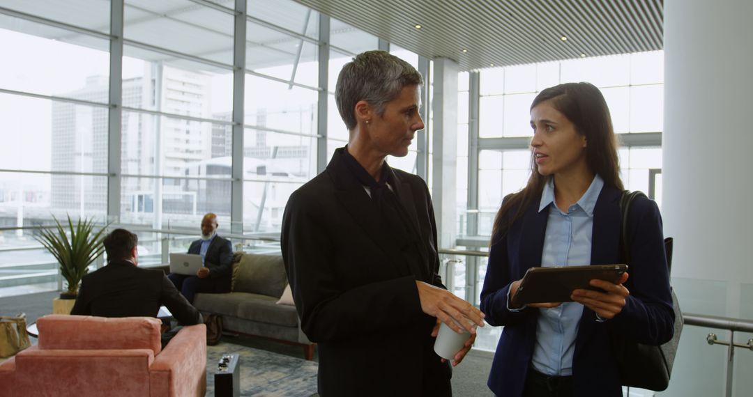 Modern Office Discussion in Bright Lobby Setting