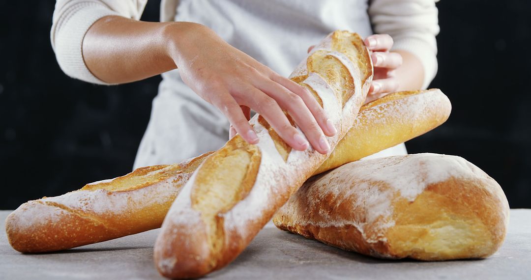 Baker Handling Freshly Baked Artisan Bread Loaves - Free Images, Stock Photos and Pictures on Pikwizard.com