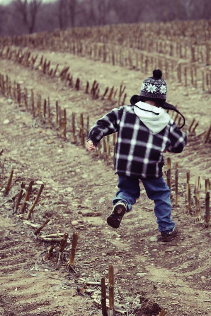 Child Running Through Harvested Field in Autumn - Free Images, Stock Photos and Pictures on Pikwizard.com