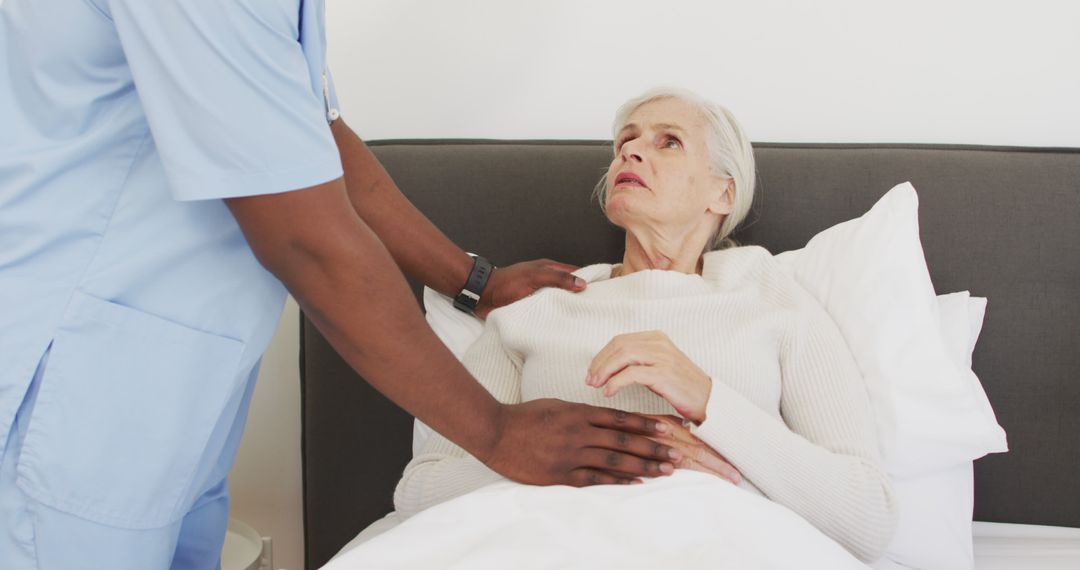 Nurse Tending to Elderly Patient in Bed - Free Images, Stock Photos and Pictures on Pikwizard.com