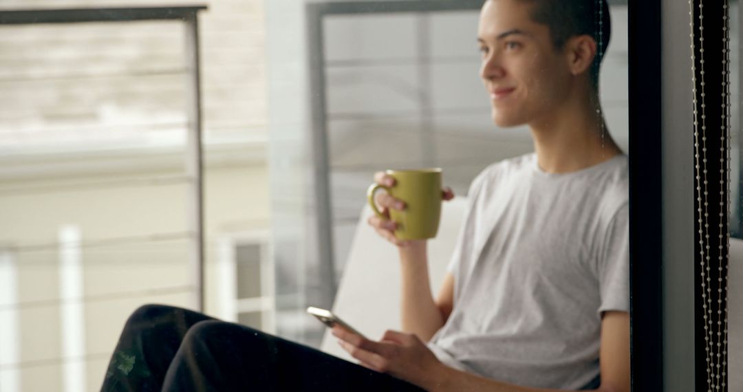 Man Relaxing on Balcony with Coffee and Smartphone - Free Images, Stock Photos and Pictures on Pikwizard.com